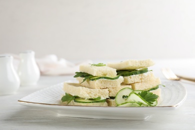 Photo of Plate with tasty cucumber sandwiches on table. Space for text