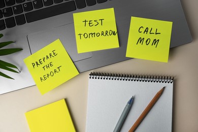 Different reminder notes and laptop on white table, flat lay