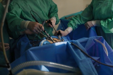 Photo of Medical team performing surgery in operating room, closeup