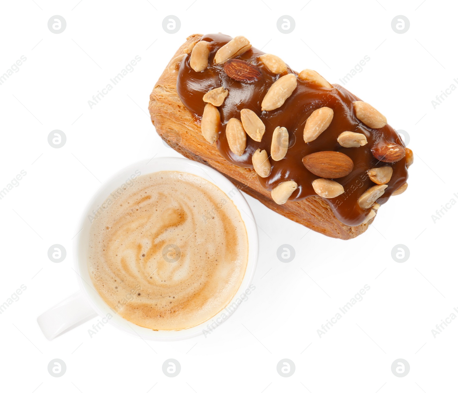 Photo of Round croissant with chocolate paste, nuts and cup of coffee isolated on white, top view. Tasty puff pastry