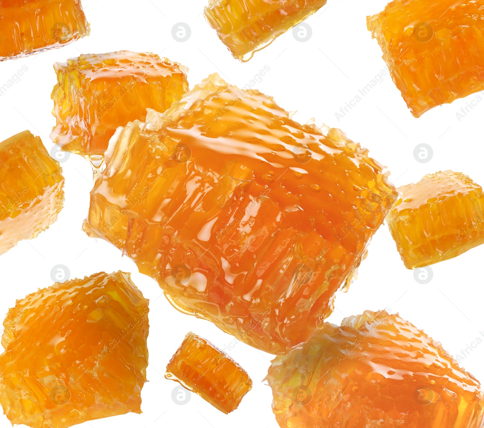 Image of Pieces of honeycomb falling on white background