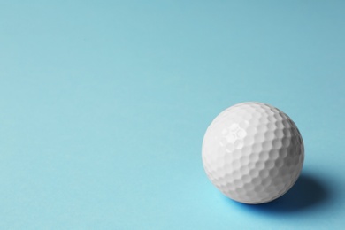 Photo of Golf ball on light blue background. Space for text