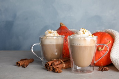 Photo of Composition with tasty pumpkin spice latte on table