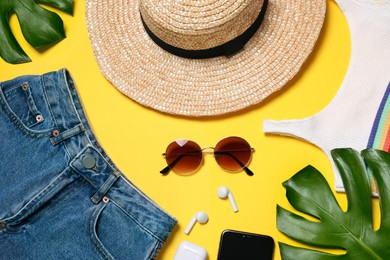 Flat lay composition with modern clothes and accessories on yellow background