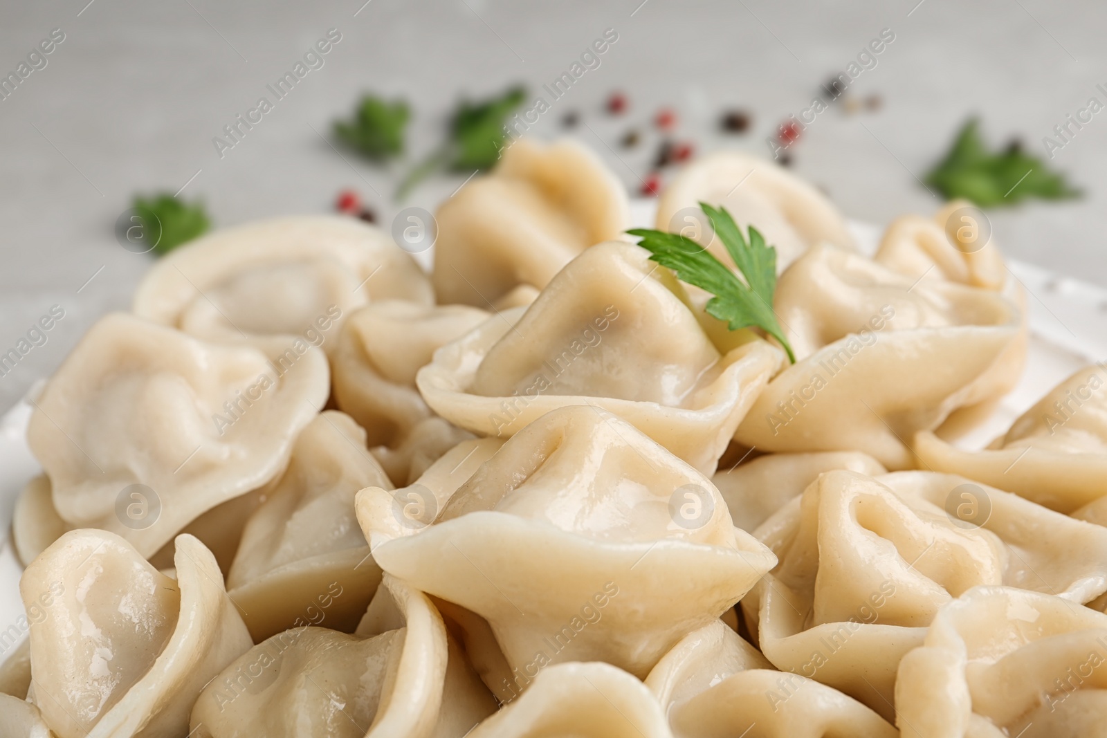 Photo of Tasty dumplings with parsley on table, closeup view