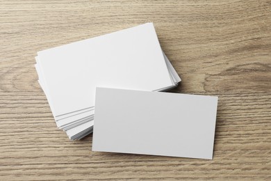 Photo of Blank business cards on wooden table. Mockup for design