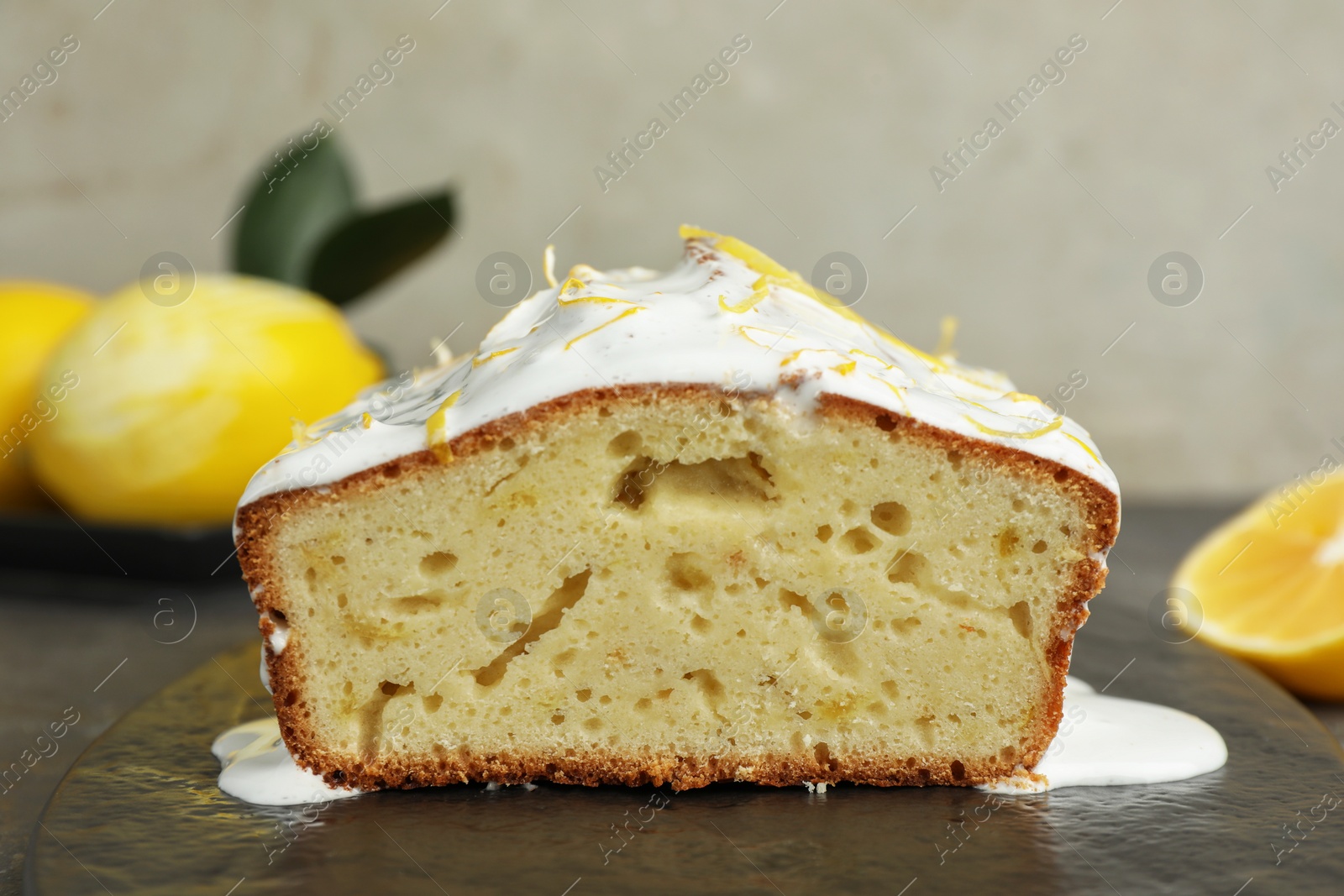 Photo of Tasty lemon cake with glaze on table, closeup