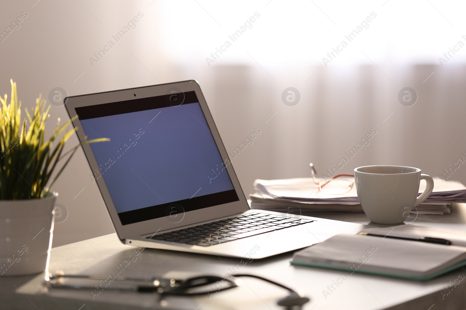 Photo of Professional doctor's workplace with modern laptop in office