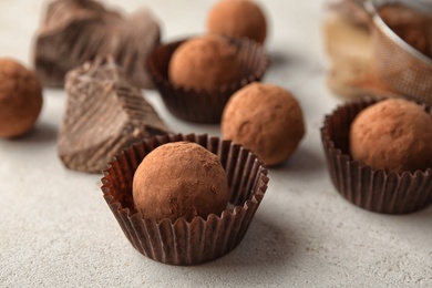 Photo of Tasty raw chocolate truffles on light background