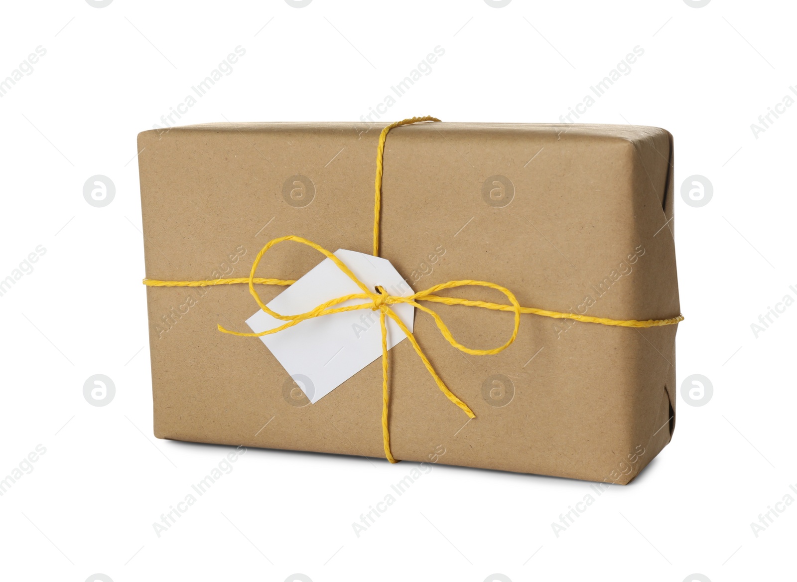 Photo of Parcel wrapped in kraft paper with tag on white background