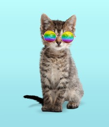 Image of Funny cat in stylish sunglasses with rainbow lenses on cyan background