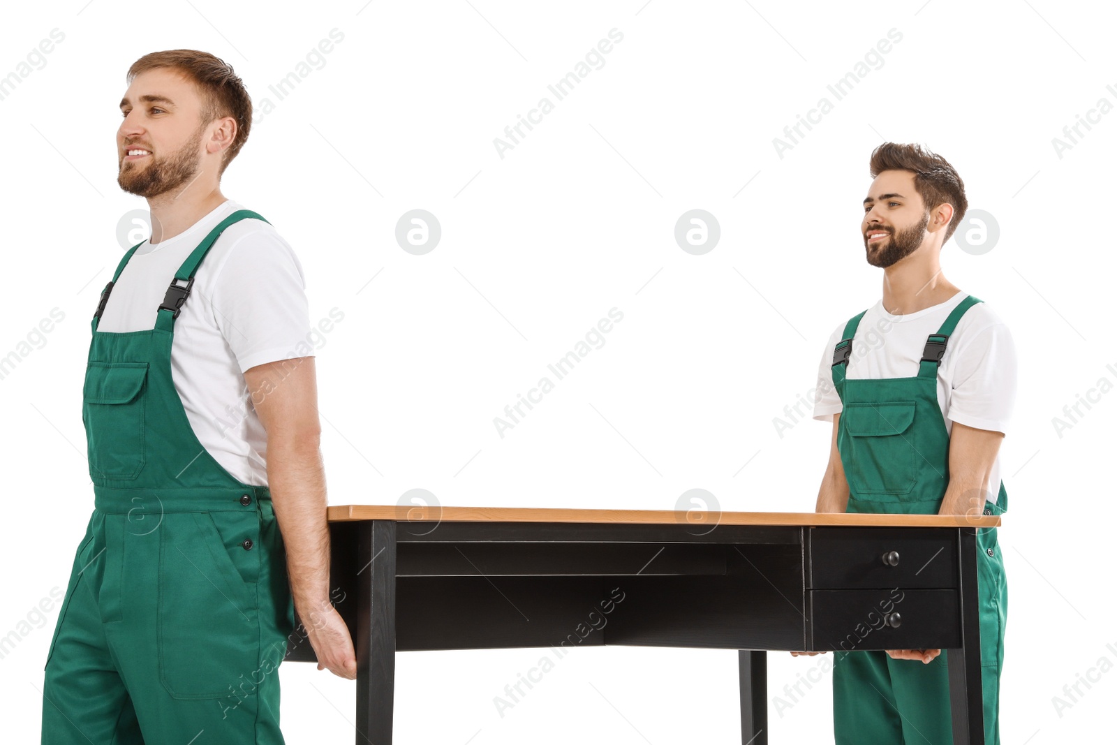 Photo of Young workers carrying table isolated on white. Moving service