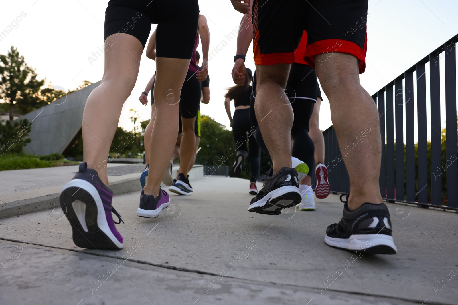 Photo of Group of people running outdoors, closeup view