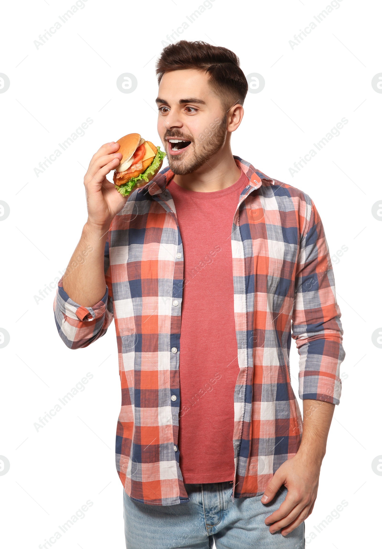Photo of Handsome man eating tasty burger isolated on white