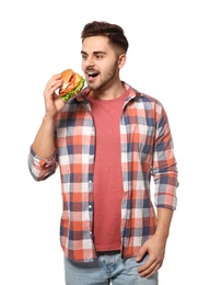 Handsome man eating tasty burger isolated on white