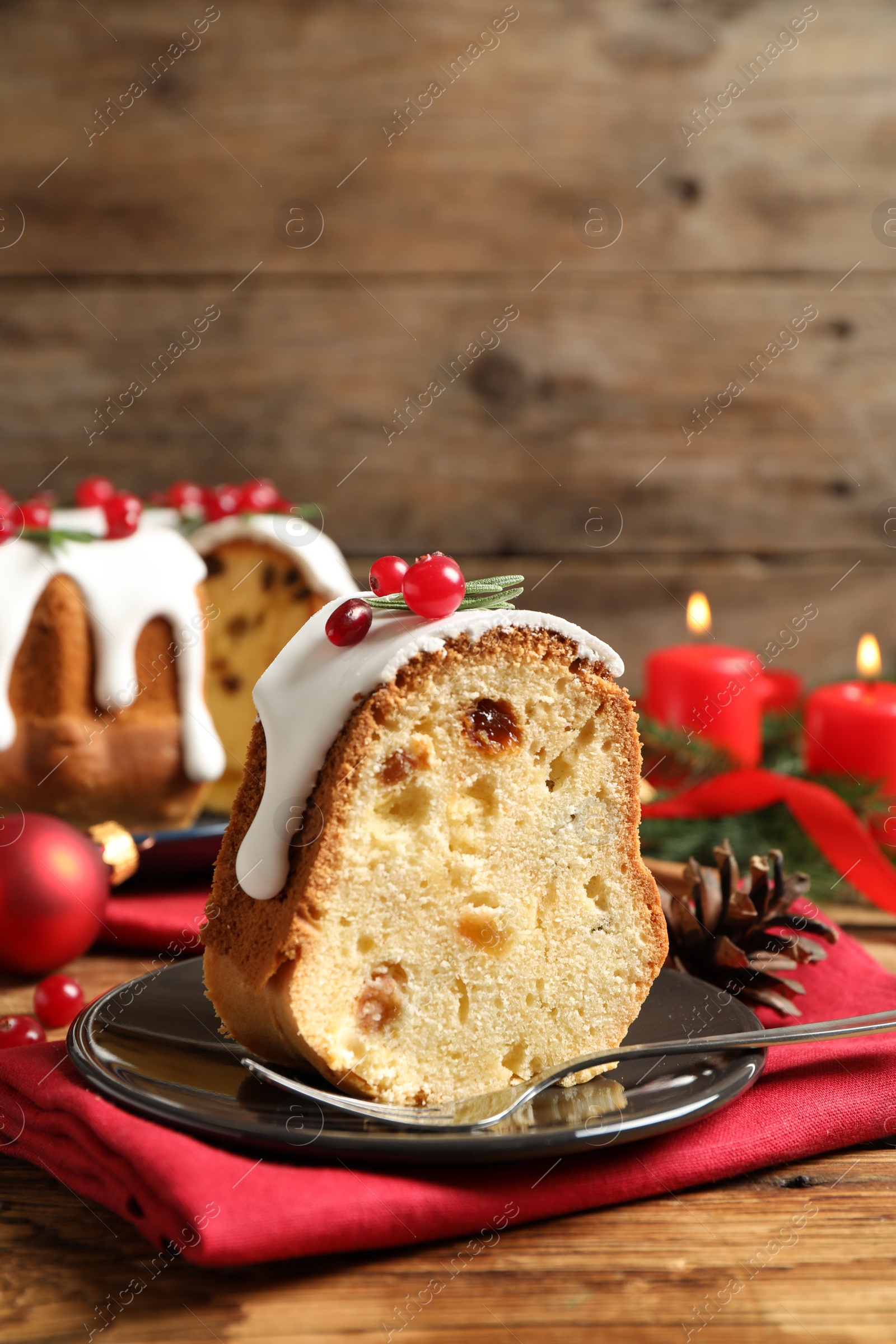 Photo of Composition with piece of traditional homemade Christmas cake on wooden table, closeup