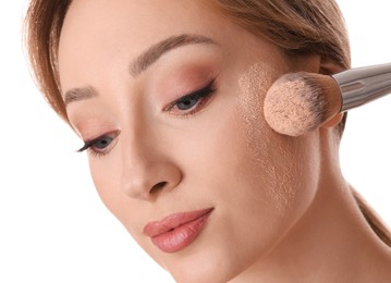 Photo of Beautiful young woman applying face powder with brush on white background, closeup