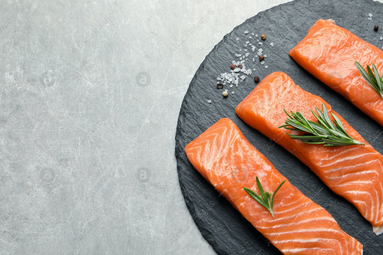 Photo of Fresh raw salmon and ingredients for marinade on grey, top view. Space for text