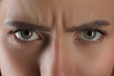 Photo of Evil eye. Young woman with scary eyes, closeup