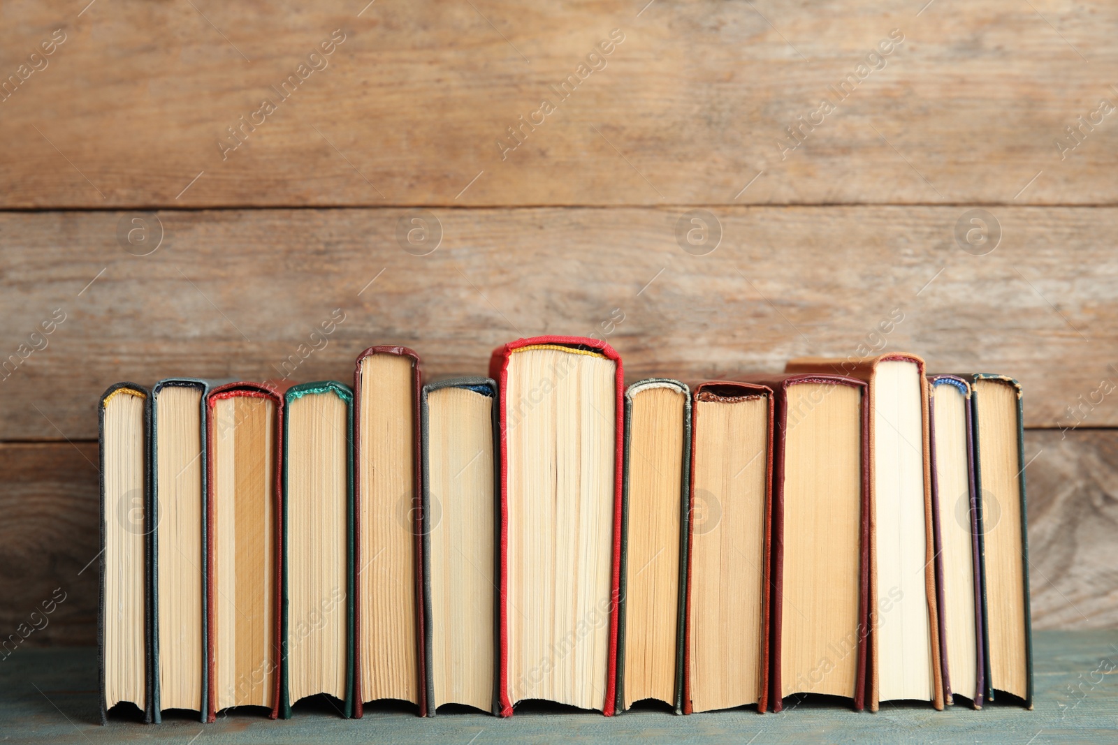 Photo of Collection of old books on wooden shelf