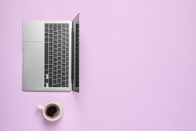 Photo of Laptop and cup of coffee on lilac background, flat lay. Space for text