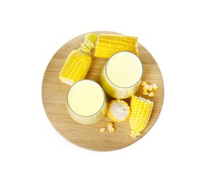 Tasty fresh corn milk in glasses and cobs on white background, top view