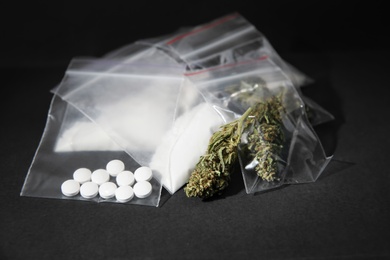 Photo of Cocaine, dried hemp and ecstasy on grey table