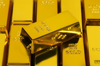 Many shiny gold bars as background, closeup