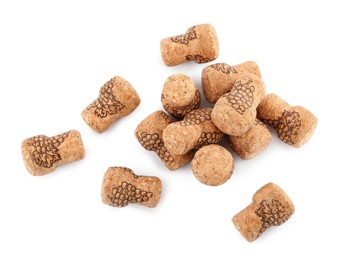 Photo of Heap of sparkling wine corks on white background, top view