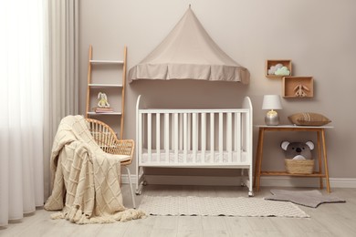 Modern baby room interior with stylish crib