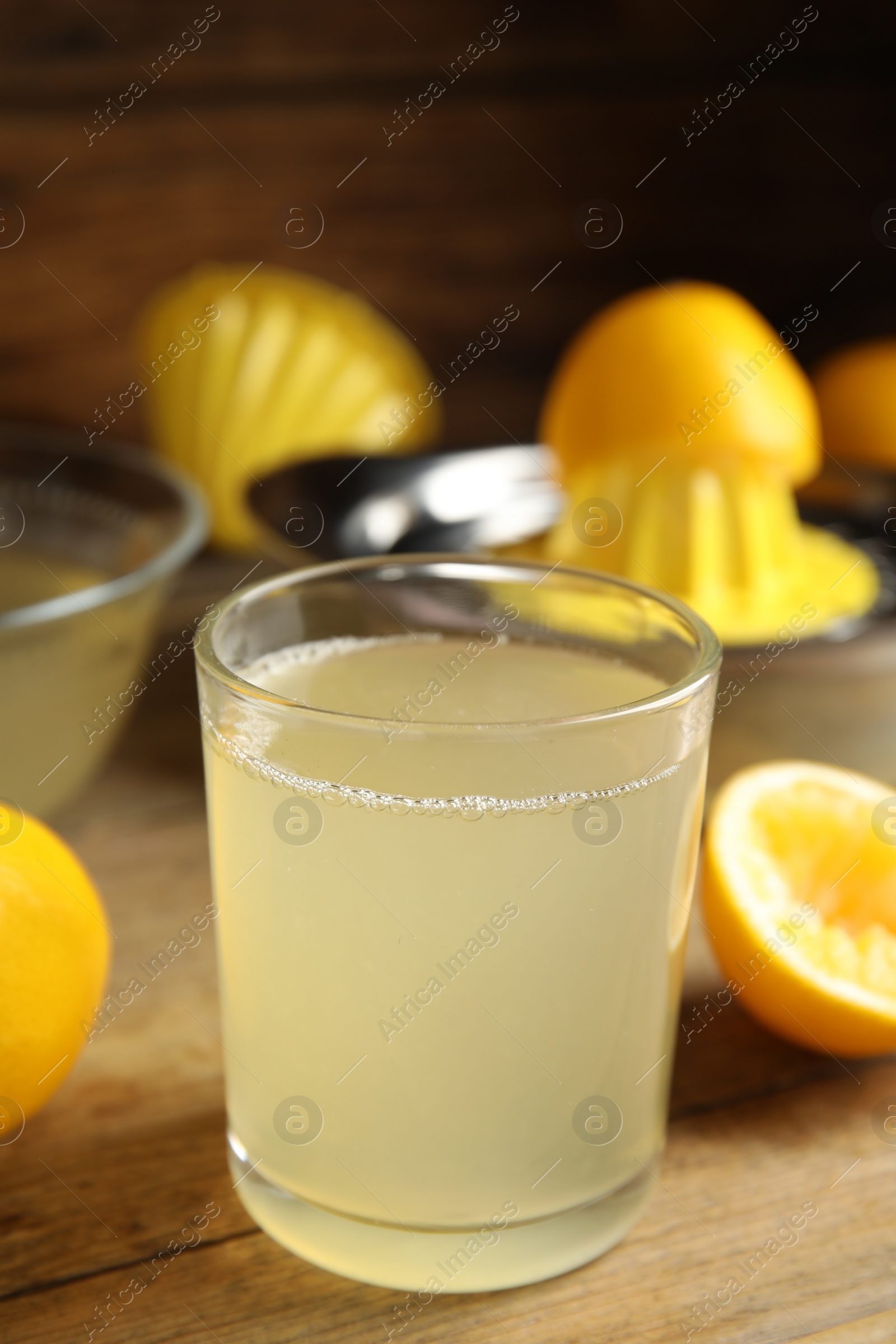 Photo of Freshly squeezed lemon juice on wooden table