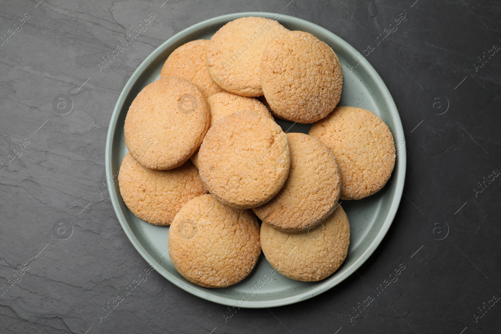 Photo of Delicious sugar cookies on black table, top view