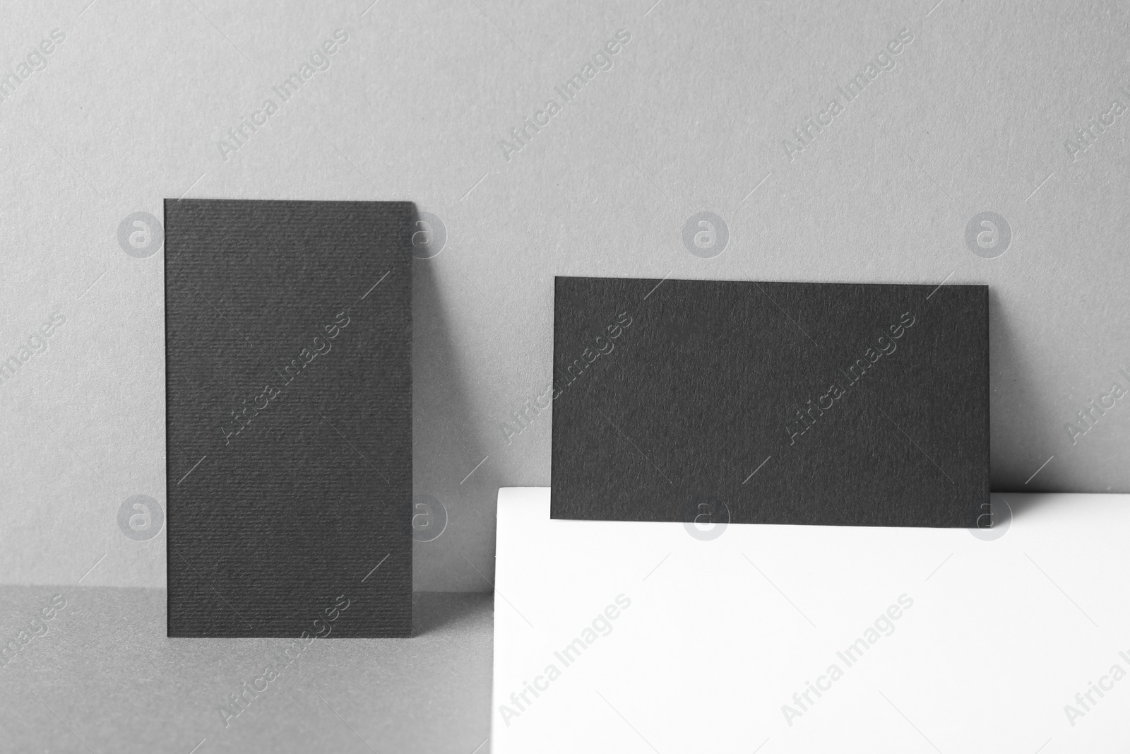 Photo of Blank black business cards on grey background. Mockup for design