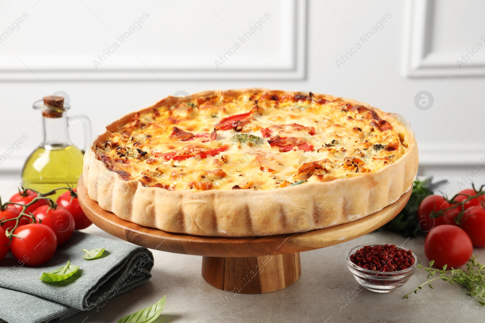 Photo of Tasty quiche and products served on light table, closeup