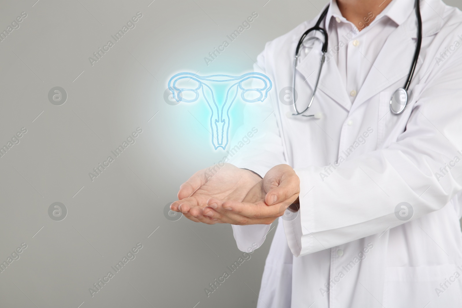 Image of Doctor and illustration of female reproductive system on grey background, closeup