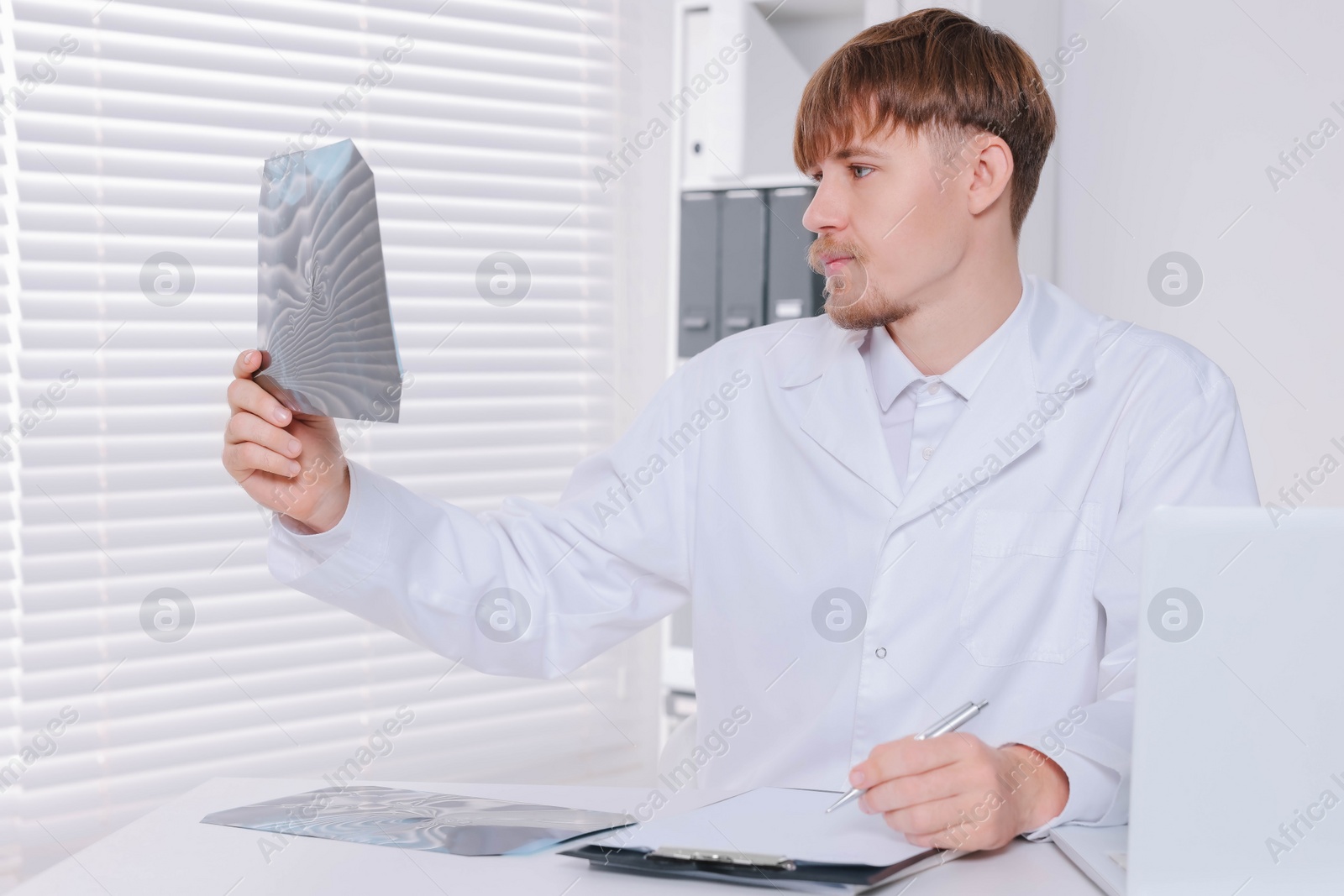 Photo of Doctor examining neck MRI image in clinic