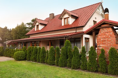 Photo of Beautiful two storey beach house and green trees outdoors