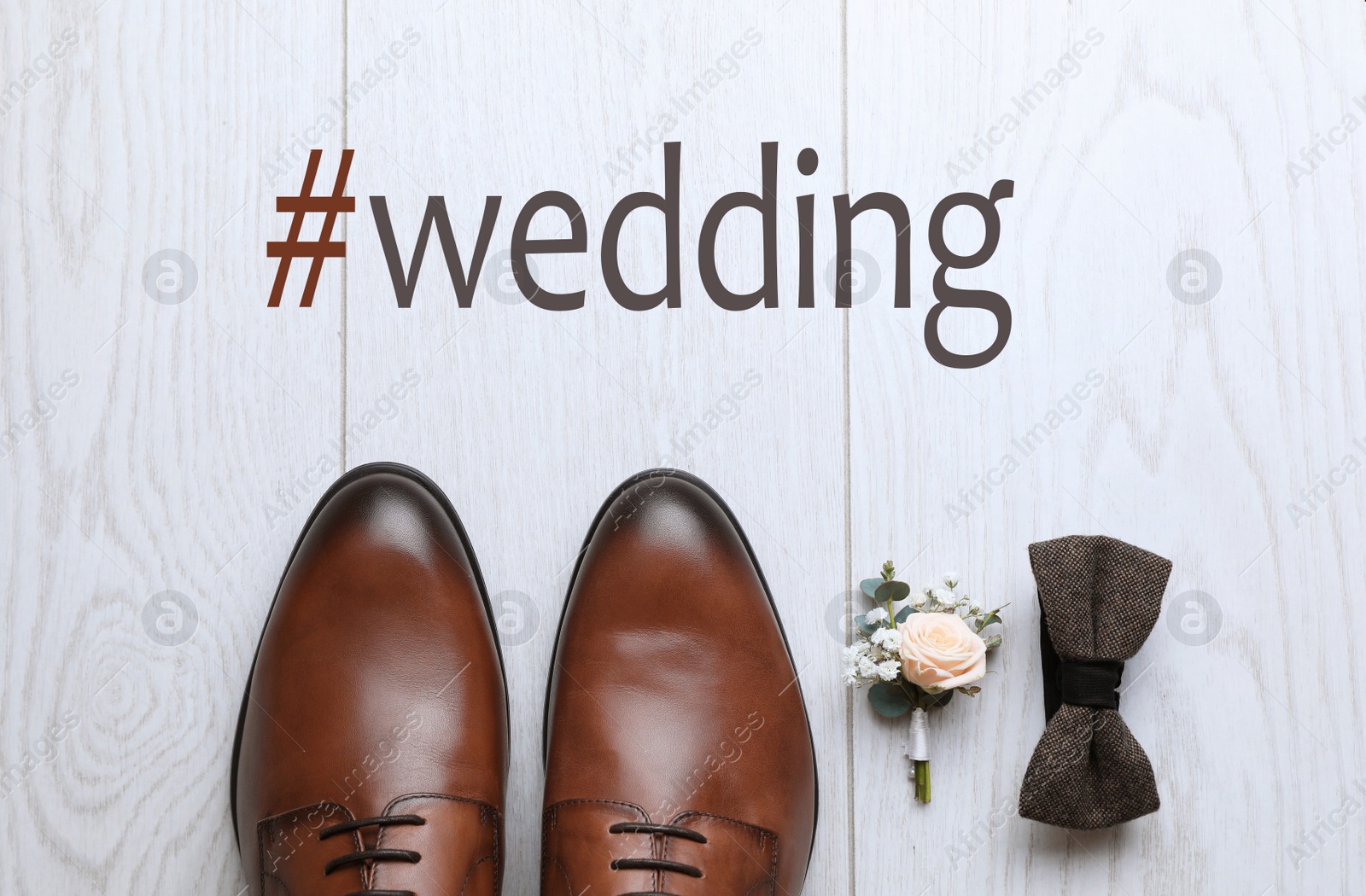 Image of Flat lay composition with shoes and hashtag Wedding on white wooden background