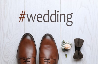 Image of Flat lay composition with shoes and hashtag Wedding on white wooden background