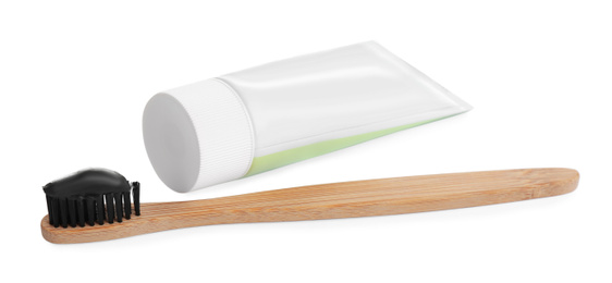 Bamboo toothbrush with charcoal paste isolated on white