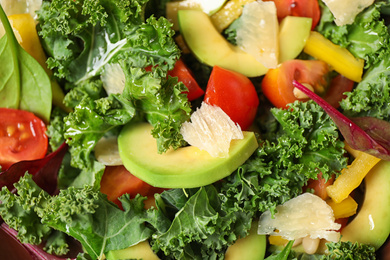 Photo of Tasty fresh kale salad as background, closeup