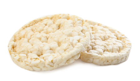 Photo of Puffed rice cakes isolated on white. Healthy snack