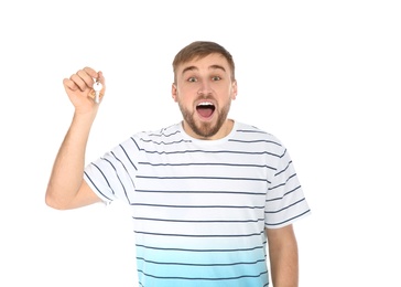 Happy young man with house key on white background