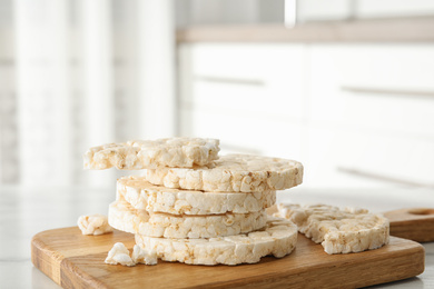 Puffed rice cakes on wooden board indoors, closeup