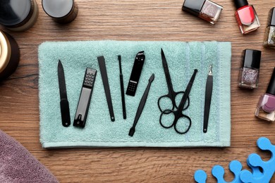 Flat lay composition with set of manicure tools on wooden table