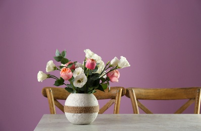 Photo of Vase with beautiful flowers as element of interior design on table in room. Space for text