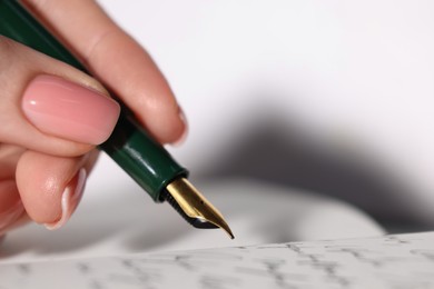 Photo of Woman writing letter with fountain pen, closeup. Space for text
