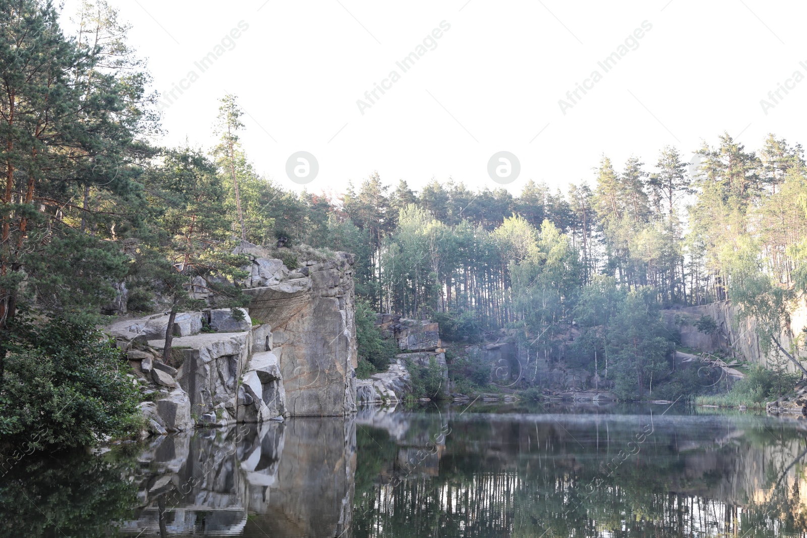 Photo of Beautiful landscape with forest and rocky mountain near lake. Camping season