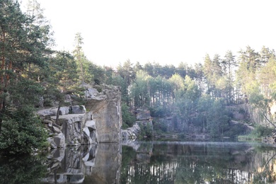 Photo of Beautiful landscape with forest and rocky mountain near lake. Camping season