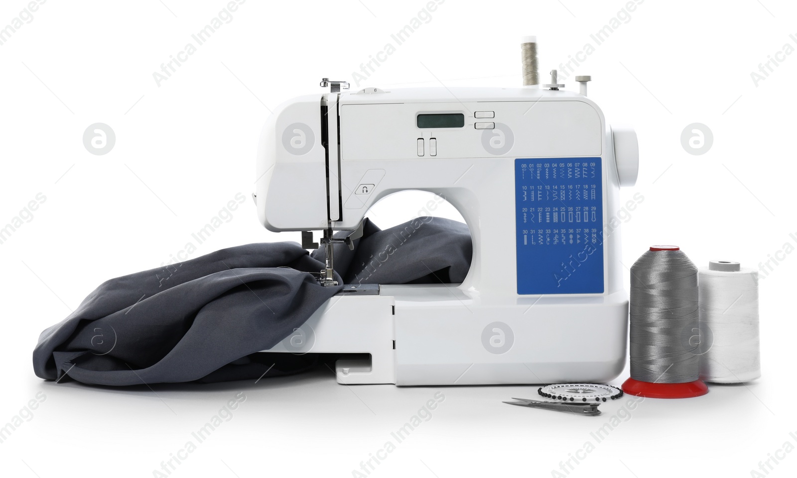 Photo of Sewing machine with fabric and craft accessories isolated on white